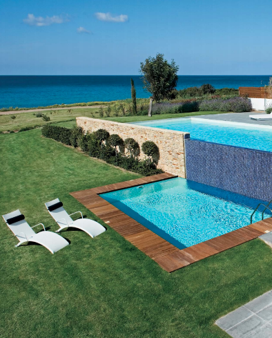 luxurious pool with deck sunbeds and garden