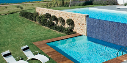 luxurious pool with deck sunbeds and garden