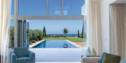 modern living room with balcony and pool view