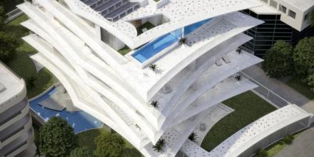 sky view of white luxurious apartment complex with swimming pools and garden